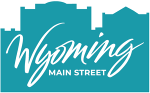 Wyoming Main Street Primary Logo in Teal with building outlines behind text