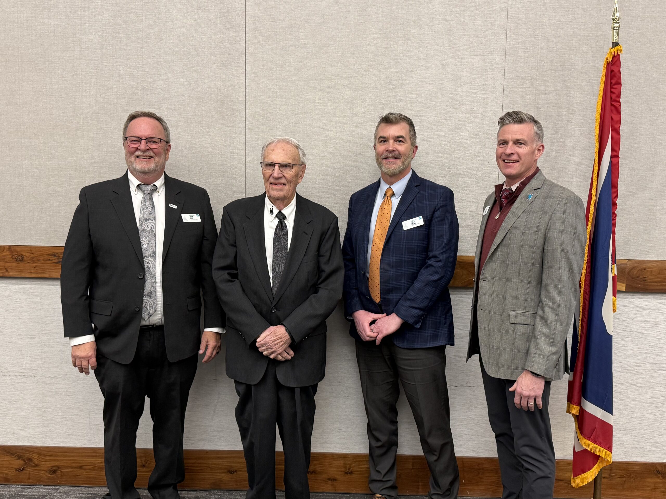 Photo of four men in suits